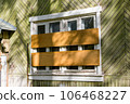 Boarded up outside windows of an old house after resettlement 106468227