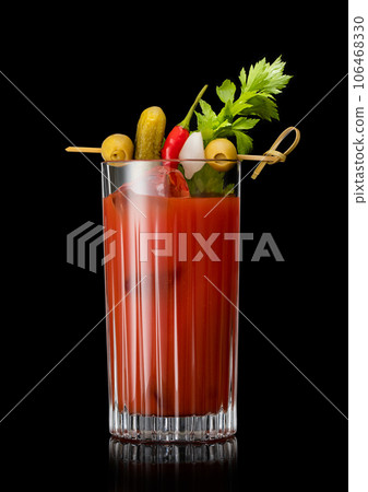 Cocktail mix with vodka and tomato juice bloody mary with celery,olive,pickle and onion on black. 106468330