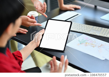 Cropped shot of male interior designer holding digital tablet, working on a home renovation sketch with colleague at office 106470557