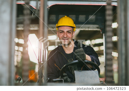 Portrait happy forklift driver wearing safety helmet and vest enjoy working transporting goods in warehouse shipping cargo 106472323