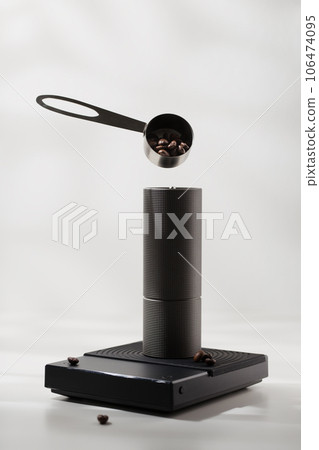 The roasted coffee beans are in a stainless steel spoon floating in the air The roasted coffee beans are in a stainless steel spoon floating in the air 106474095