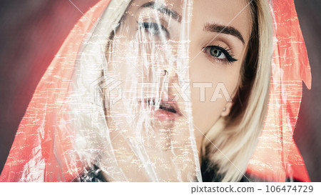 Laser surgery. Vision correction. Aesthetic medicine. Beautiful woman half covered face with glitch noise animation plastic film on neon red light. 106474729