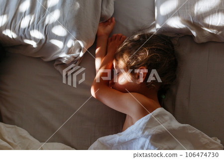 little girl sleeping in parents bed in the morning light little girl sleeping in parents bed in the morning light 106474730