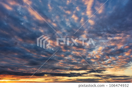 Colorful fluffy clouds in sunset sky at twilight 106474932