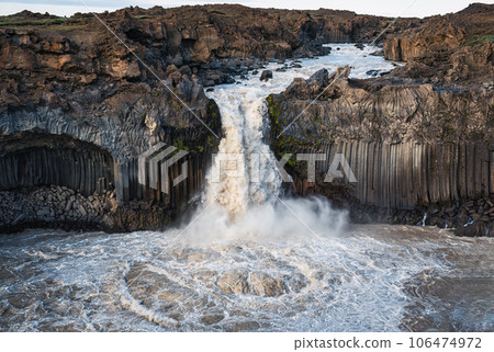 Powerful Aldeyjarfoss waterfall flowing from ancient Badardalshraun lava field and basalt column in summer at Iceland Powerful Aldeyjarfoss waterfall flowing from ancient Badardalshraun lava field and basalt column in summer at Iceland 106474972