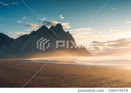 Sunrise over Vestrahorn mountain on black sand beach in summer at Stokksnes peninsula Sunrise over Vestrahorn mountain on black sand beach in summer at Stokksnes peninsula 106474979