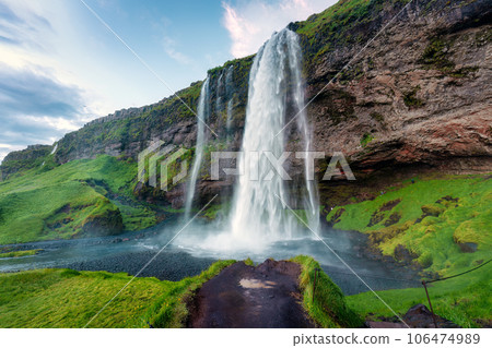 Seljalandsfoss waterfall flowing and lush mountain in summer at Iceland. 106474989