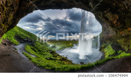 Natural cave with Seljalandsfoss waterfall flowing in summer at Iceland 106474994