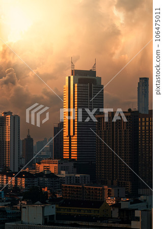 Golden sunrise shining on modern office building in downtown at Bangkok 106475011