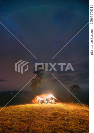 Tent camping with starry on hill in night sky 106475012