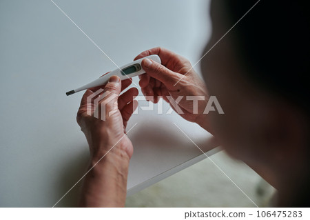 Senior woman measuring fever with a thermometer 106475283