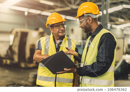 Asian male workers team work meeting talking consulting together in heavy industry factory Asian male workers team work meeting talking consulting together in heavy industry factory 106476362