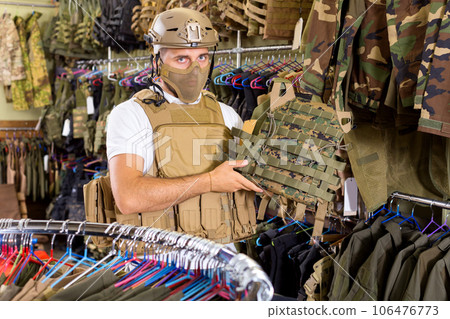 Male customer try on ammunition with rifle Male customer try on ammunition with rifle 106476773