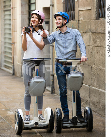 couple traveling by segways 106476860