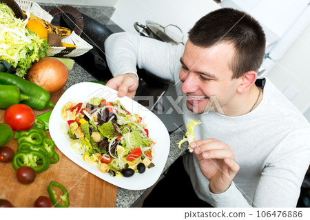 Portrait of male with vegetables dish 106476886