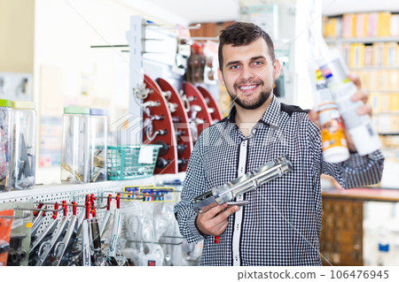 Man choosing new glue gun 106476945