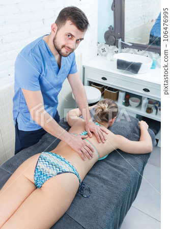 Massage therapist making massage to adult girl Massage therapist making massage to adult girl 106476995