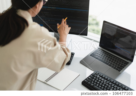 Developer programmer checking code on monitor while programming to developing web and application Developer programmer checking code on monitor while programming to developing web and application 106477103