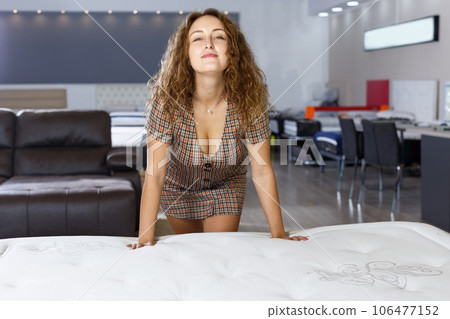Woman choosing mattress in furnishings store Woman choosing mattress in furnishings store 106477152