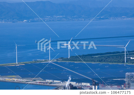 A wind turbine standing by the sea and receiving sea breeze 106477175