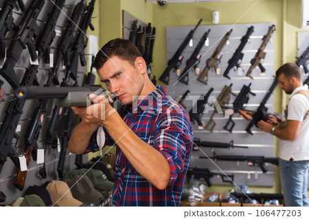 Men choosing air weapon Men choosing air weapon 106477203