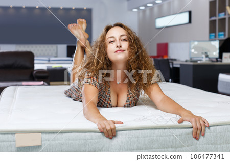 girl testing quality of new mattress 106477341