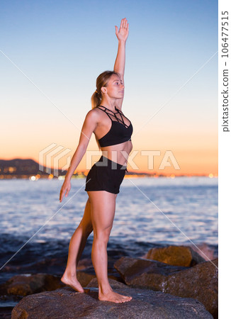 Adult woman is practicing stretching 106477515