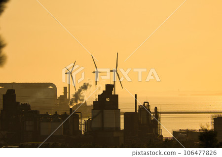 A wind turbine for wind power generation standing by the sea in the evening and receiving the sea breeze A wind turbine for wind power generation standing by the sea in the evening and receiving the sea breeze 106477826