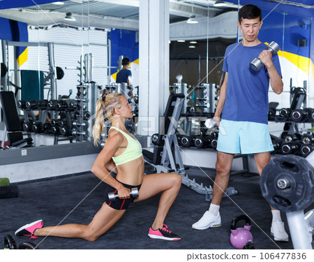 Couple during weightlifting workout 106477836