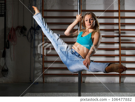 Girl engaged on pylon in semidarkness Girl engaged on pylon in semidarkness 106477882