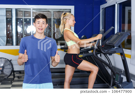 Confident trainer posing at gym Confident trainer posing at gym 106477900