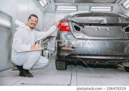 car body painter professional male worker checking color paint detail in auto garage bodywork shop car body painter professional male worker checking color paint detail in auto garage bodywork shop 106478329