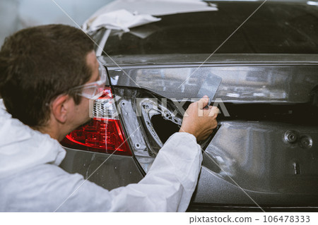 car body painter painting select paint colors using sample card for pick choice color shade in auto garage body workshop car body painter painting select paint colors using sample card for pick choice color shade in auto garage body workshop 106478333