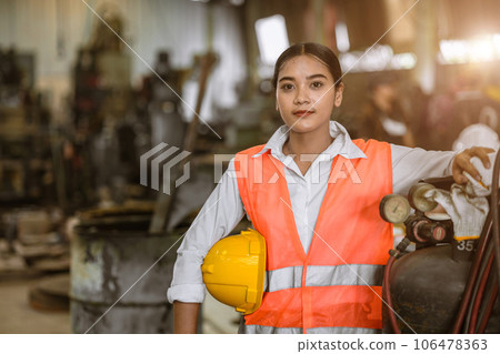 portrait happy young asian woman worker with heavy metal machine lathe milling factory industry portrait happy young asian woman worker with heavy metal machine lathe milling factory industry 106478363
