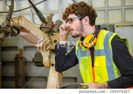 smart young engineer work service maintenace programming automatic robot welding machine in heavy metal automation factory smart young engineer work service maintenace programming automatic robot welding machine in heavy metal automation factory 106478367