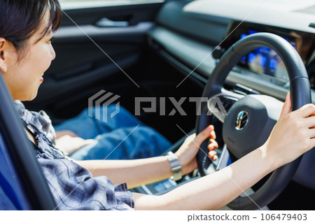 A young woman driving with her friends 106479403