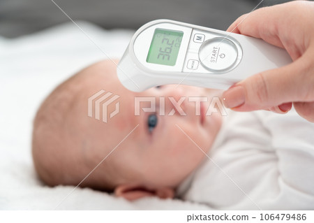 Digital tools aid a mother's health check on infant. Concept of technology in baby care 106479486