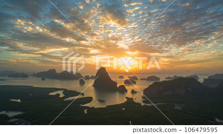 aerial view Amazing light of nature cloudscape sky above Samed Nang Chee Phang Nga archipelago. Imagine a fantasy bright red sky at sunrise from a bird's eye view. tropical landscape background. aerial view Amazing light of nature cloudscape sky above Samed Nang Chee Phang Nga archipelago. Imagine a fantasy bright red sky at sunrise from a bird's eye view. tropical landscape background. 106479595