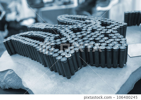 Emblem, coat of arms of Ukraine trident from used cartridges. Object made up of spent used cartridge cases. Lots used shells from cartridge cases ammo close up. Model from Many Used cartridge Cases. 106480245