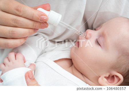 Newborn gets nasal care while sleeping, Concept of mother's loving attention 106480357