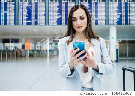 business woman at airport in front of display business woman at airport in front of display 106481468
