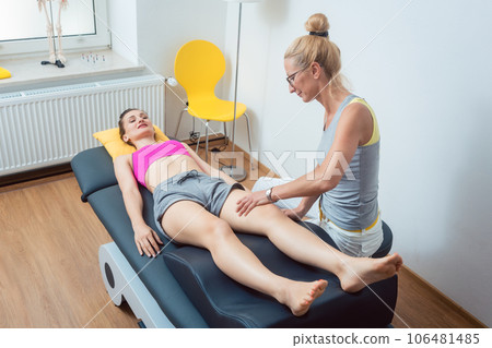 Physical therapist working on knee of woman Physical therapist working on knee of woman 106481485