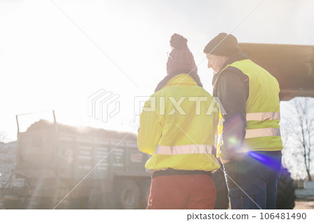 Manager and worker in biomass compost works engaged in discussion 106481490