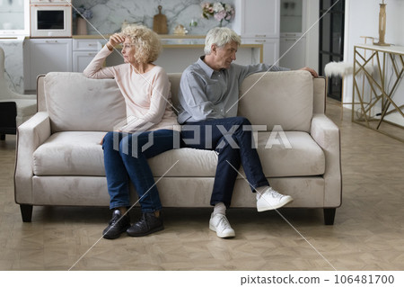 Angry frustrated tired senior couple sitting separately on home couch 106481700