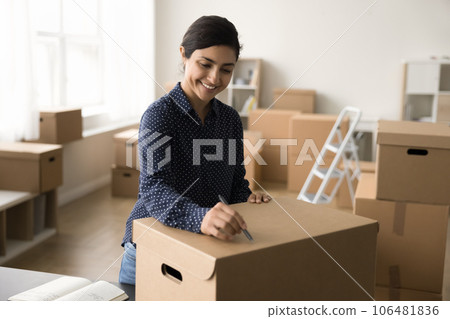 Positive beautiful Indian online shop manager preparing purchase for sending 106481836