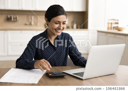 Happy satisfied Indian freelancer woman doing accounting job at home 106481866