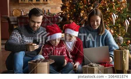 Addicted to modern technology happy family using different gadgets. 106481874