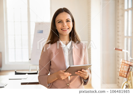 Portrait of smiling woman employee work on tablet in office 106481985