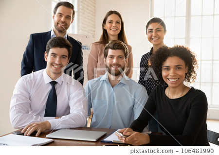 Portrait of young multiracial team posing in office Portrait of young multiracial team posing in office 106481990