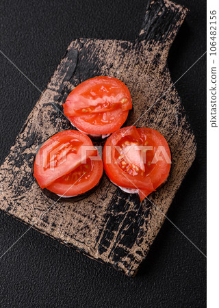 Delicious eggplant cut into circles grilled and cooked with mayonnaise and tomatoes Delicious eggplant cut into circles grilled and cooked with mayonnaise and tomatoes 106482156